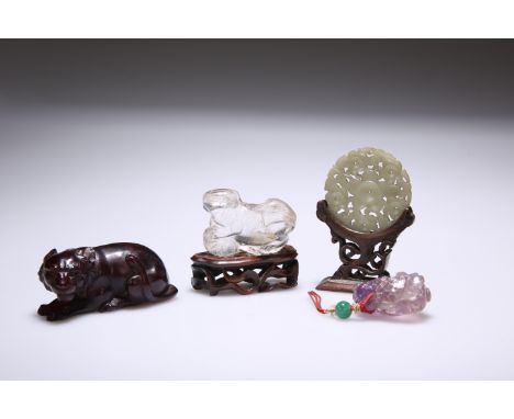 A CHINESE AMBER MODEL OF A TIGER, bears paper label to base, 8cm; together with A ROCK CRYSTAL CARVING OF A SHISHI, on a wood
