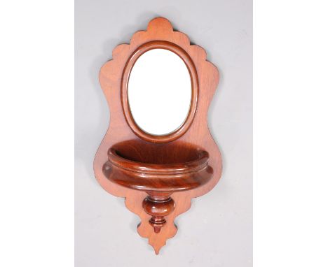 A VICTORIAN MAHOGANY MIRROR-BACK HANGING SHELF, with oval mirror plate and demilune shelf. 57cm high