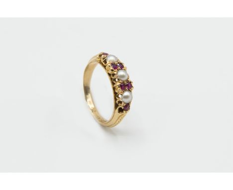 A MID VICTORIAN RING, the three seed pearls and six garnet highlights each set in pierced mounts between solid tapering shoul