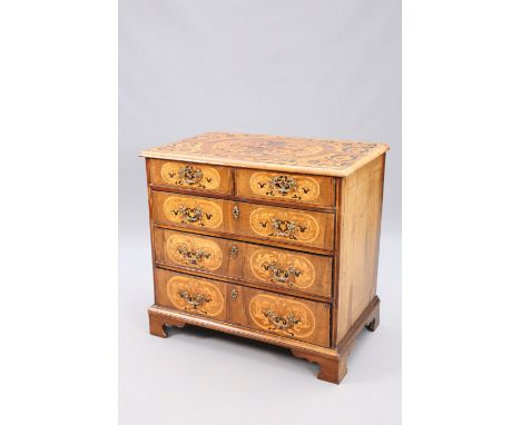 AN 18TH CENTURY MARQUETRY AND WALNUT COMMODE, PROBABLY SOUTH GERMAN, the moulded rectangular top inlaid with scrolling foliag