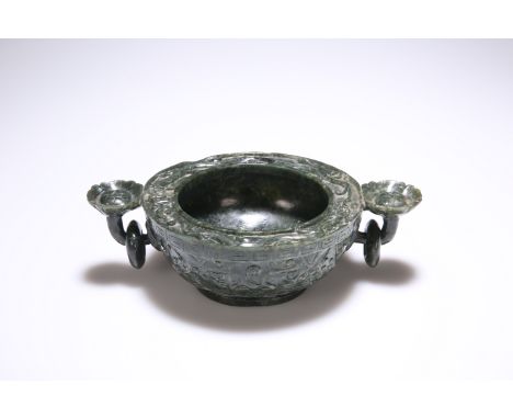 A CHINESE NEPHRITE JADE ARCHAIC STYLE CENSER, circular with twin ring handles. 24cm across handles