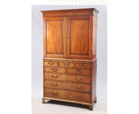 A GEORGE III MAHOGANY PRESS, the upper section with projecting cornice above a pair of fielded panel doors, opening to reveal
