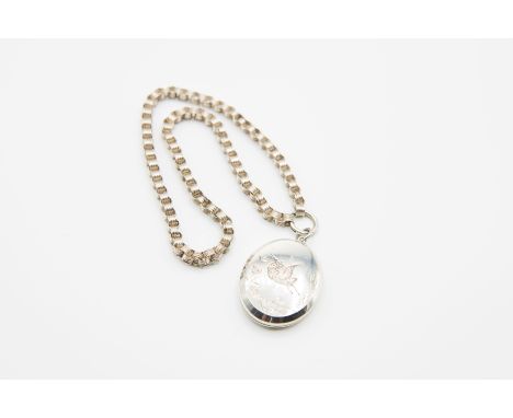 A VICTORIAN LOCKET NECKLACE, the large oval locket pendant engraved to the centre with a bird amongst foliage, suspending fro