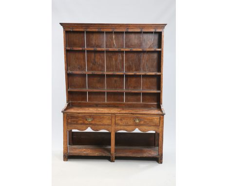 AN ENGLISH OAK DRESSER AND RACK, 18TH CENTURY, the enclosed rack with moulded cornice and three shelves, the base with two dr