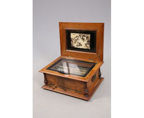 A WALNUT CASED POLYPHON DISC MUSIC BOX, with two 4 1/2-inch combs, one numbered 77848, the cover decorated with birds and ins