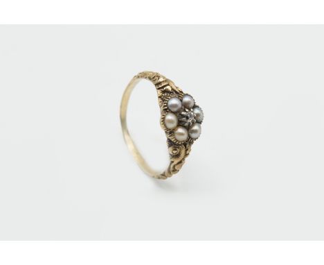A LATE GEORGIAN SEED PEARL AND DIAMOND RING, the flower head shaped mount set with six seed pearls and a single old cut diamo