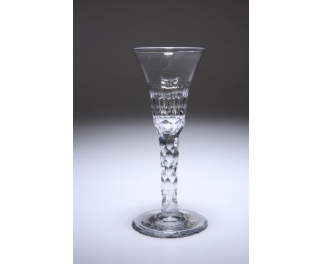 A FACET STEMMED WINE GLASS, c. 1780, the bell bowl with a scale-cut band, raised on a tapering stem cut with hexagonal facets