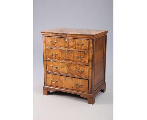 A SMALL WALNUT CHEST OF DRAWERS, the crossbanded top above four long drawers fitted with brass swan-neck handles, the sides o