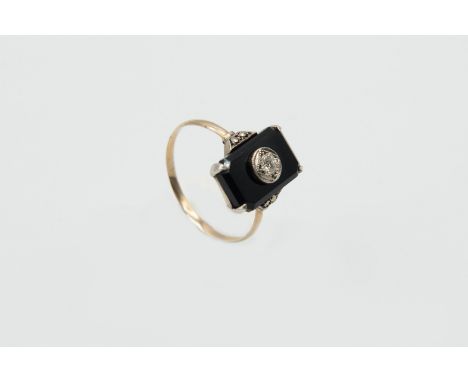 A BLACK ONYX AND DIAMOND RING, circa 1900-1910, the rectangular cut black onyx set to the centre with a single old brilliant 