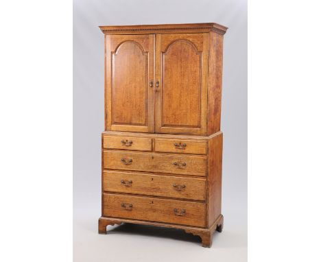 A GEORGE III OAK PRESS, EARLY 19TH CENTURY, the upper section with moulded projecting cornice above dentil moulding over a pa