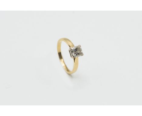 AN 18CT YELLOW GOLD AND DIAMOND RING, the square cut diamond claw set in a simple mount between pierced tapering shoulders on