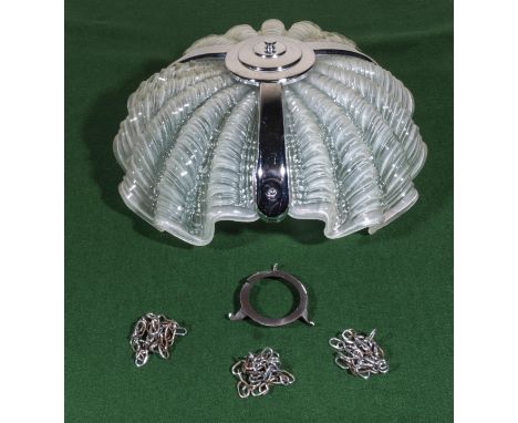 A vintage ceiling light shade in the shape of a shell