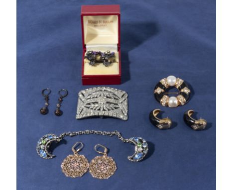 A collection of vintage costume jewellery including a belt buckle, three pairs of earrings, matching brooch and earrings