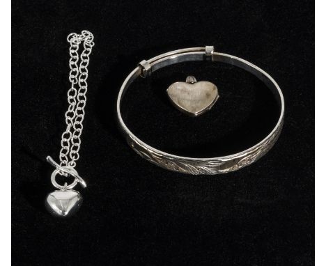 A silver bangle, bracelet and a locket