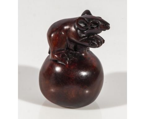 Hand carved hardwood netsuke of a rat on an apple