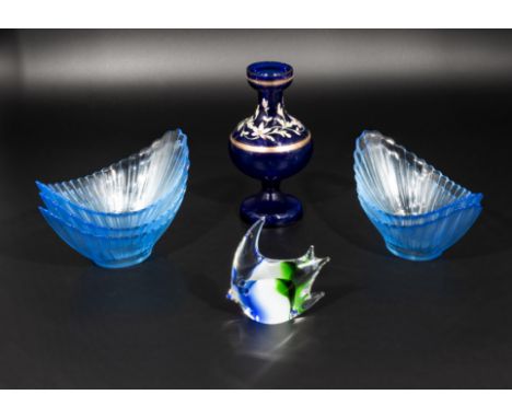 Five blue glass melon dishes, a fish and vase
