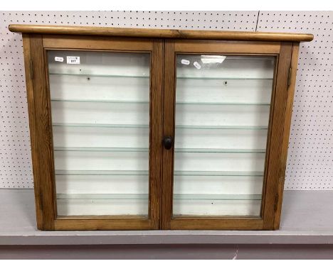 A Wall Mounted Double Door Glass Fronted Display Cabinet with glass shelves 82cm w x 67cm h x 10cm d.