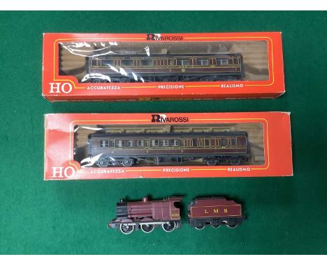 A Lima HO scale LMS 0-6-0 locomotive and tender and two boxed Rivarossi HO scale LMS coaches, untested.