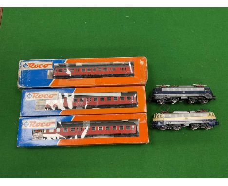 Two HO scale German electric locomotives by Fleischmann, together with three boxed German coaches by Roco, all playworn and u