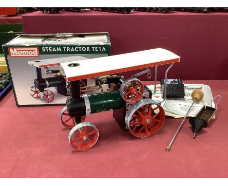 A Mamod 'Live Steam' Tractor TE1A. Accessories include Burner, Scuttle, Steering Rod, Funnel. Lightly steamed, patches of whi