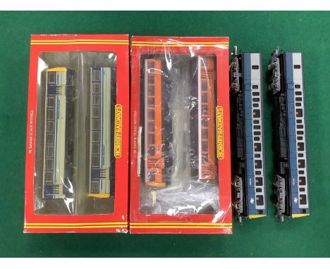 Three 00 gauge Diesel Multiple Units: two boxed Hornby two car "Pacer" trains, one in Regional Railways livery and one in Gre