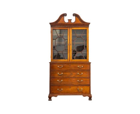 A George III padouk-wood secretaire-bookcase, the swan-neck pediment with dentil moulding and carved foliate roundels, above 