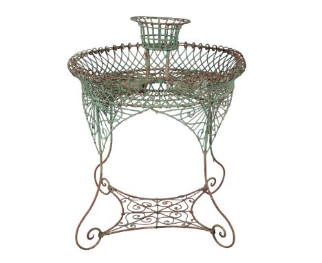 A WROUGHT-IRON AND GREEN-PAINTED JARDINIERE STAND 20th century, with lattice-work and scrolled surround, on scrolling legs jo