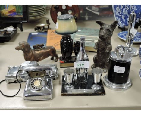 An assortment of vintage lighters including novelty begging terrier and dachshund desk lighter.