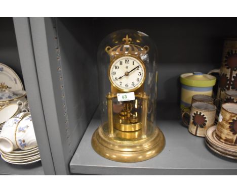 A vintage brass anniversary clock having glass dome and enamel face,marked for Badische.