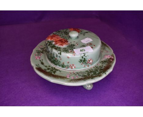A Chinese export or similar green celadon glaze koro or similar three footed lidded dish decorated with enamel cherry blossom