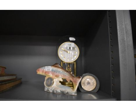 A glass domed anniversary clock by Kundo