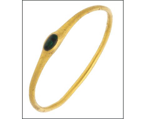 A Medieval gold and emerald ring, circa 1200-1400, the plain circular hoop of slender tapering form, centred with a small ova