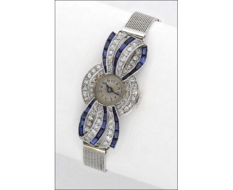 Swiss. A lady’s white precious metal, diamond and sapphire-set cocktail watch, circa 1930 Movement: jewelled, manual winding 