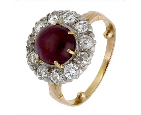 A cabochon ruby and diamond cluster ring, the ruby cabochon within a surround of old brilliant-cut diamonds, total diamond we