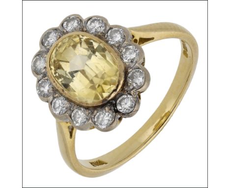 An 18ct gold yellow sapphire and diamond cluster ring, the mixed-cut yellow sapphire within a scalloped surround of brilliant