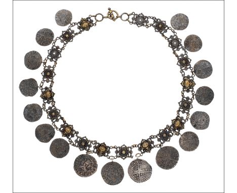 A hammered coin fringe necklace, composed of scrollwork links alternately applied with female masks and suspending seventeen 