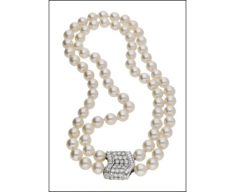 A cultured pearl necklace with diamond clasp by Adler, the two rows of cultured pearls, measuring approximately 8.5mm, to a c
