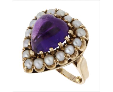 An amethyst and pearl cluster ring, 1970, the heart-shaped amethyst cabochon within a surround of seed pearls, stamped ‘DHJ’,