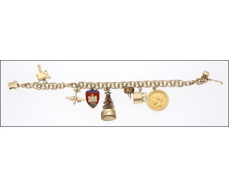A charm bracelet, the multi-link chain suspending seven charms, including a George V half-sovereign, a 9ct gold Wigan Warrior