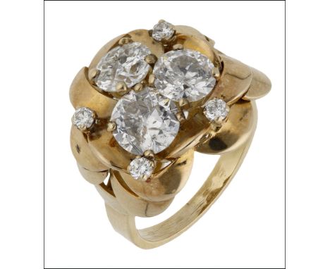 A diamond dress ring, set with three old brilliant-cut diamonds within a surround of overlapping petals, further set with fou