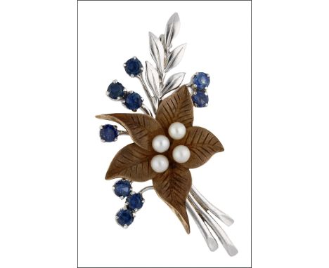 A sapphire and seed pearl brooch by Cropp & Farr, 1966, the bicoloured floral spray with circular-cut sapphires and cultured 