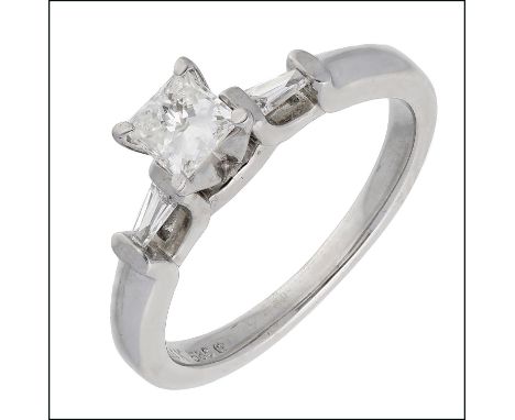 A diamond ring, claw set with a princess-cut diamond, weighing 0.39 carat, between tension-set tapered baguette-cut diamonds,