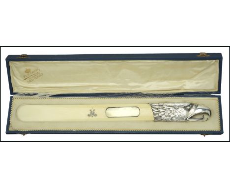 A late 19th century silver mounted eagle head ivory letter opener/page turner, the head with open beak, piercing eye and well