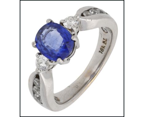 A sapphire and diamond dress ring, the oval-shaped sapphire between two brilliant-cut diamonds, to graduated channel-set diam