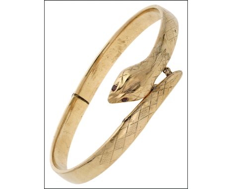 A 9ct gold serpent bangle, the hollow hinged bangle with bead click clasp and red stone eyes, with trace-link safety chain, h