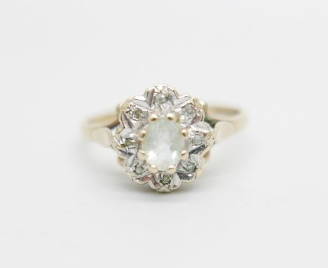 A 9ct gold ring set with a clear central stone and diamond chip halo, 2.2g, O 