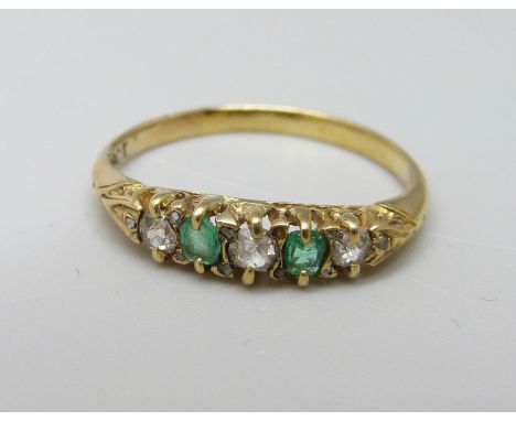 An 18ct gold, emerald and diamond seven stone ring, 2g, J 