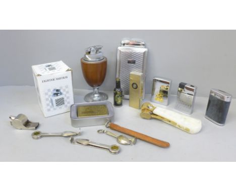 A collection of smoking items including cigar cutter, lighters, pipe cleaners, etc. 