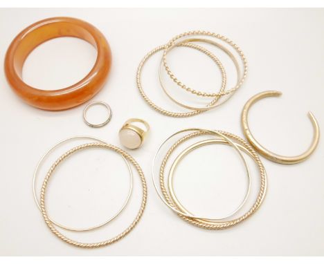 A collection of gold tone bangles and a ring, and one other bangle 