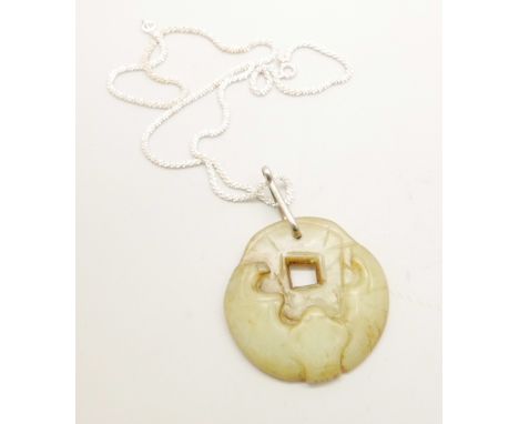 A jade pendant on a chain 